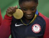 Simone Biles poses with her medal after winning the gold at the women's team final. REUTERS/Dylan Martinez