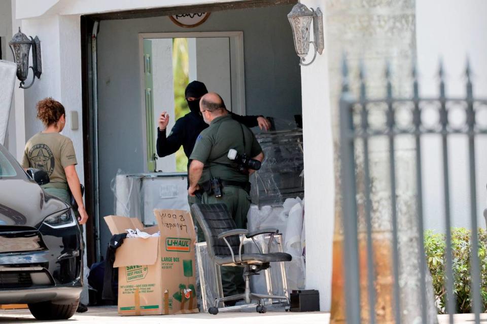 Broward Sheriff’s Office personnel move items in the garage at Sean Kingston’s Southwest Ranches home on Thursday, May 23, 2024. A woman named Janice Turner, 61, was arrested on “numerous fraud and theft charges,” during the raid at the sprawling white mansion in the 4600 block of Southwest 178th Avenue, spokesperson Carey Codd said in a media release. Turner is Kingston’s mother, according to reports. (Amy Beth Bennett / South Florida Sun Sentinel)