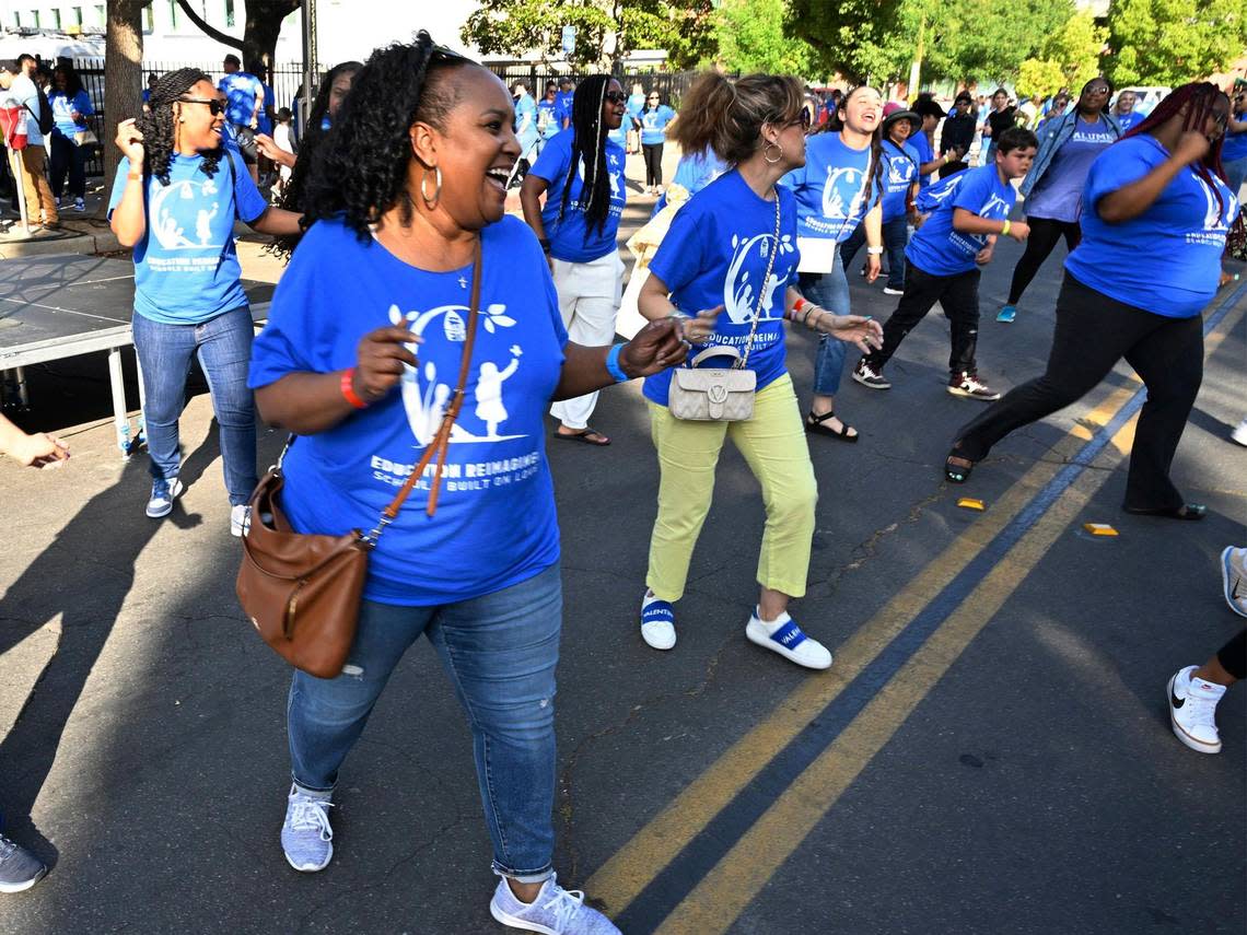 Teachers dance in front of the stage as over 1,000 teachers and supporters gathered for an Education Rally & Block Party organized by Fresno Teachers Association along N Street while the Fresno Unified board met in downtown Fresno on Wednesday, May 24, 2023 .