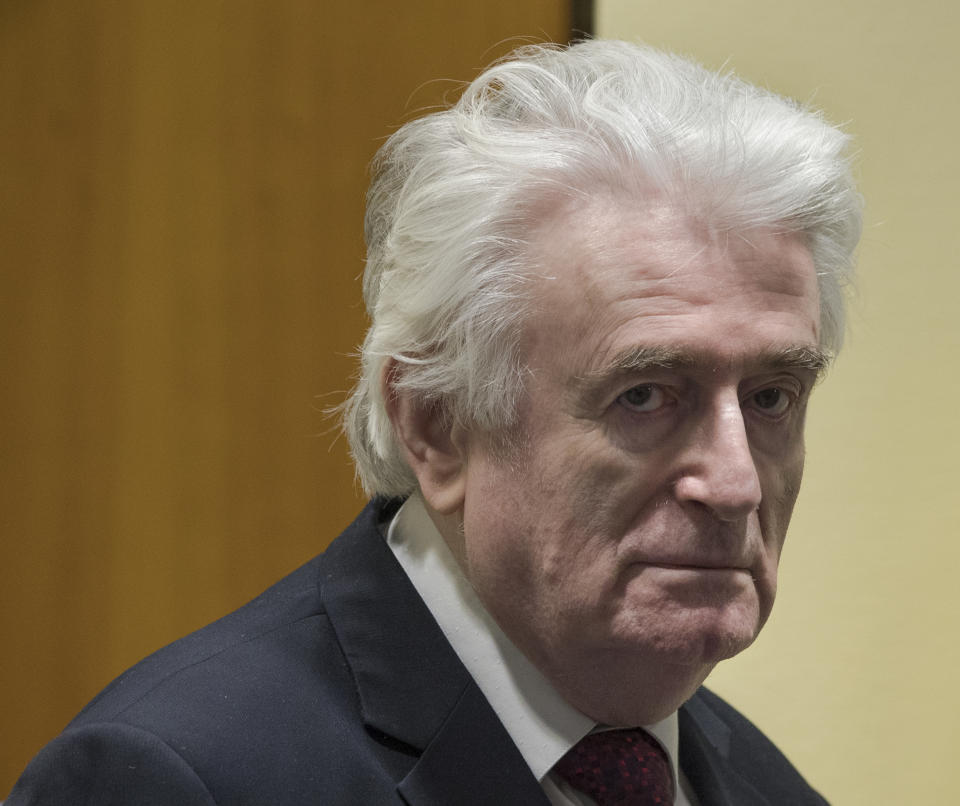 Former Bosnian Serb leader Radovan Karadzic enters the court room of the International Residual Mechanism for Criminal Tribunals in The Hague, Netherlands, Wednesday, March 20, 2019. Nearly a quarter of a century since Bosnia's devastating war ended, Karadzic is set to hear the final judgment on whether he can be held criminally responsible for unleashing a wave of murder and destruction. United Nations appeals judges will on Wednesday rule whether to uphold or overturn Karadzic's 2016 convictions for genocide, crimes against humanity and war crimes, as well as his 40-year sentence. (AP Photo/Peter Dejong, Pool)