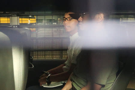 Democracy leader Joshua Wong sits in a prison van as he arrives at the High Court in Hong Kong, China August 22, 2017. REUTERS/Stringer