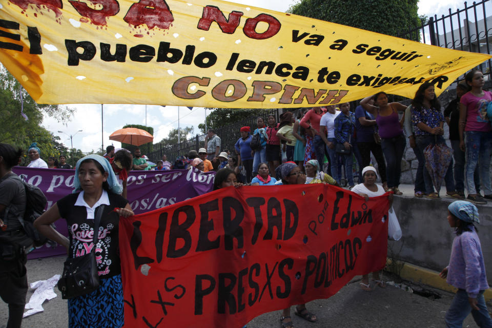 Friends and activists gather outside the court room to demand justice for the murder of environmental activist and Goldman Environmental Prize winner Berta Caceres, in Tegucigalpa, Honduras, Monday, Sept. 17, 2018. Honduras' supreme court has indefinitely suspended the start of the trial of eight men accused in the 2016 killing of Caceres, citing five related filings pending at the criminal appeals court that have to be resolved. (AP Photo/Fernando Antonio)