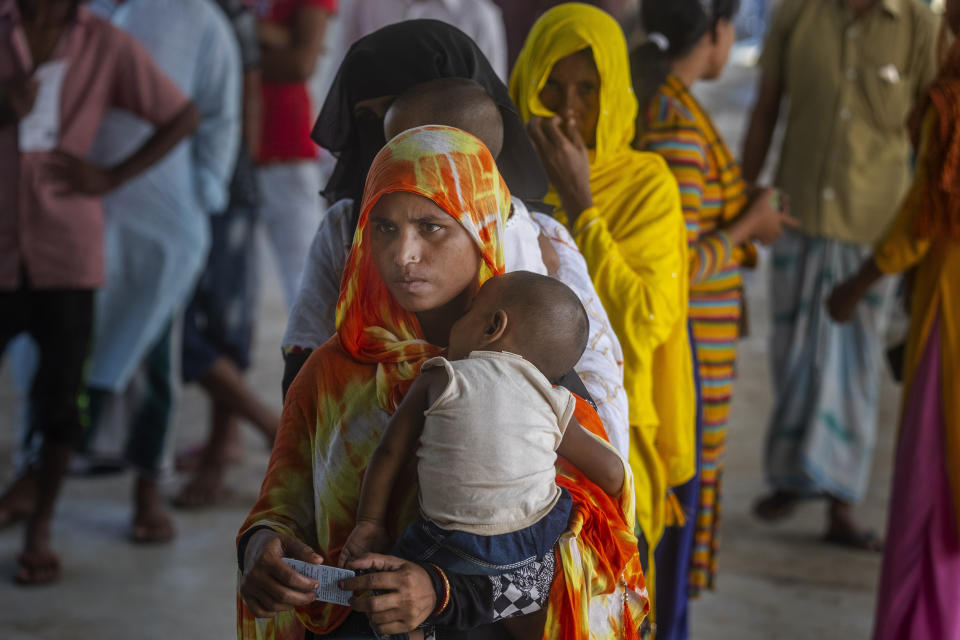 Women stand in a queue to receive the vaccine for COVID-19 in Khola Bhuyan village on the outskirts of Gauhati, India, Tuesday, Sept. 7, 2021. (AP Photo/Anupam Nath)