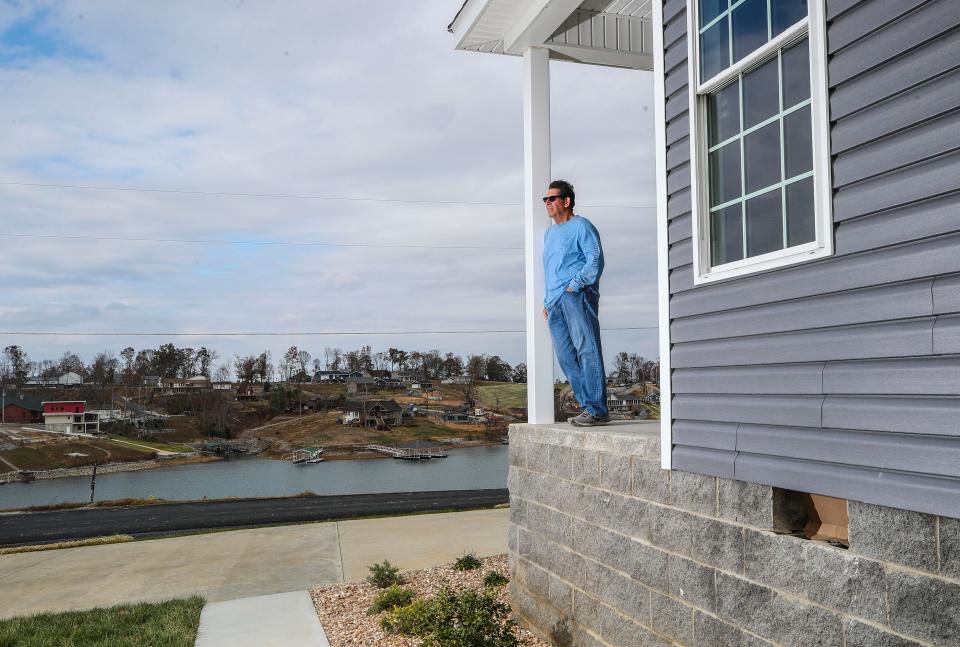 Robert Freeman stands on the porch of his replacement home being built. Freeman and his wife lost their home in the December 2021 tornados that ripped through Western Kentucky. The couple moved into their original home in 2019. Freeman said the replacement cost was around $175,000 more than his original home due to material shortages and labor. Some of Freeman's neighbors are rebuilding; a few others are not. Nov. 16, 2022.