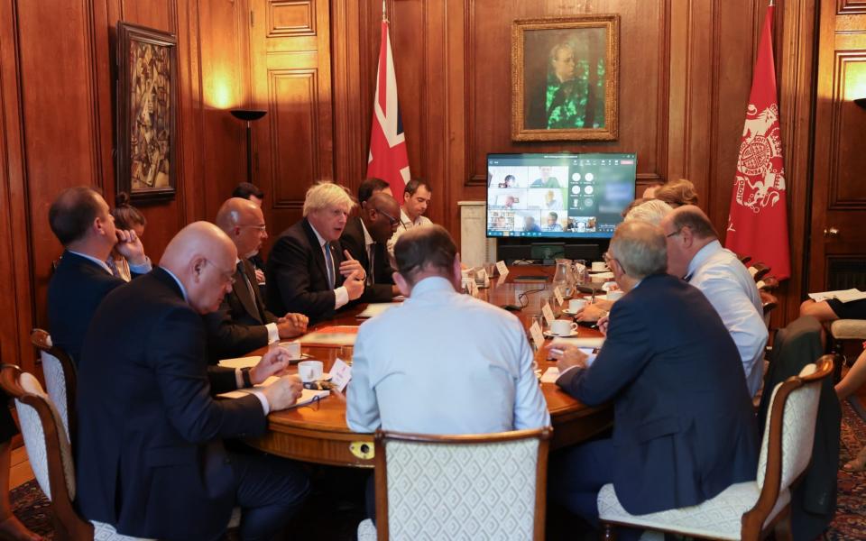 Boris Johnson is pictured meeting with energy bosses in Downing Street today - Downing Street 