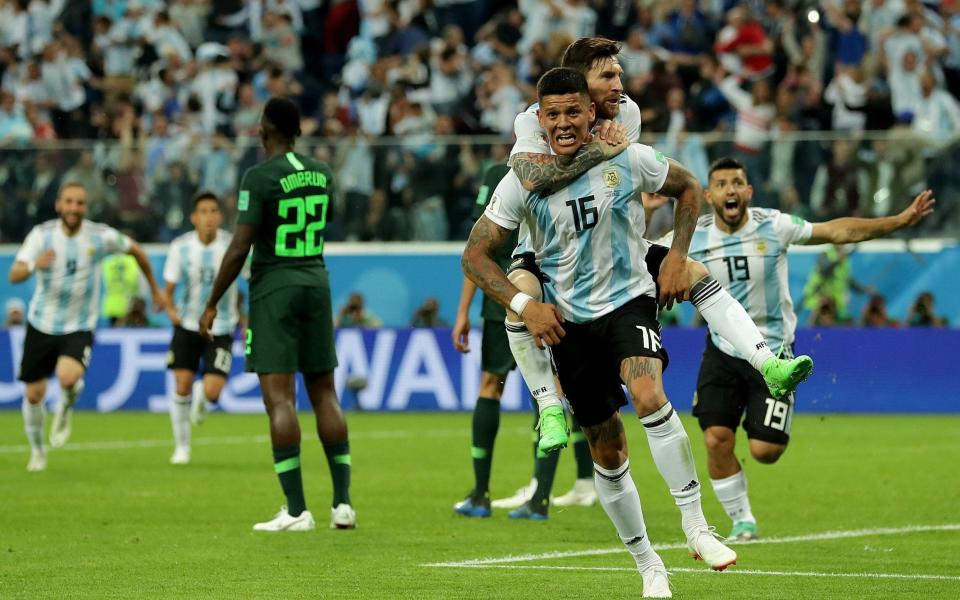 Marcos Rojo is mobbed by team-mates after scoring Argentina's late winner - Getty Images Europe