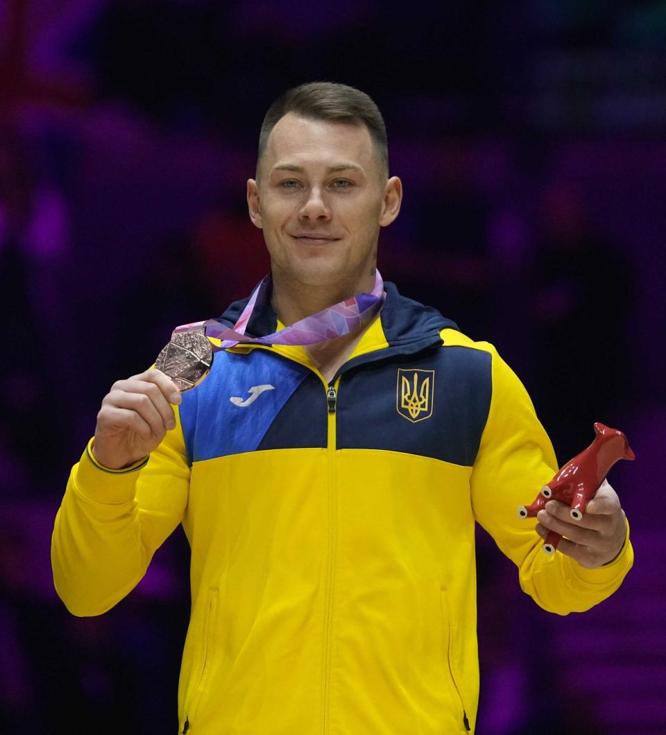 Bronze medallist Ukraine's Igor Radivilov celebrates during the medal ceremony for the vault finals during the Artistic Gymnastics World Championships at M&S Bank Arena in Liverpool, England, Sunday, Nov. 6, 2022. (AP Photo/Thanassis Stavrakis)