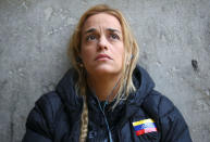 Lilian Tintori, wife of jailed Venezuelan opposition leader Leopoldo Lopez, looks on as she sits on the pavement near St. Peter's Square in Rome, Italy December 6, 2016. REUTERS/Stefano Rellandini