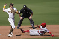 San Diego Padres shortstop Jake Cronenworth, left, throws to first too late for the double play as Los Angeles Angels' David Fletcher slides in late to second base during the fifth inning of a baseball game Wednesday, Sept. 23, 2020, in San Diego. Los Angeles Angels' Jared Walsh was out at safe at first on the fielder's choice. (AP Photo/Gregory Bull)