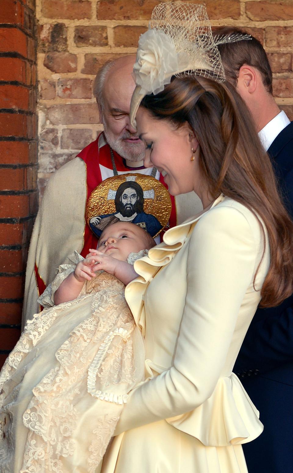 The Duchess of Cambridge carries her son Prince George following his christening at the Chapel Royal in St James's Palace by the Archbishop of Canterbury in central London.