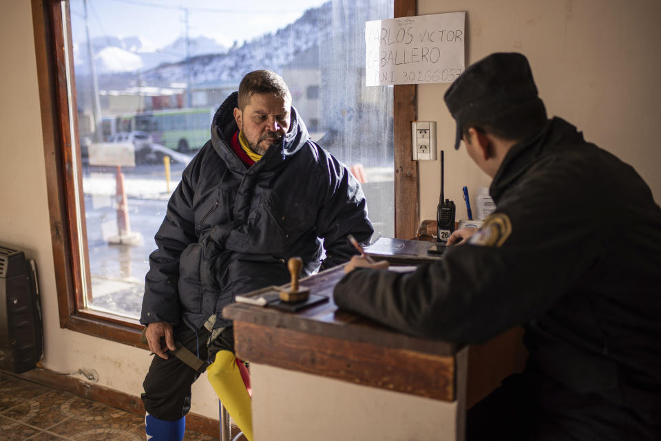 Venezuelan Yeslie Aranda registers his arrival at a police police station in Ushuaia, Argentina, the southernmost city in the world, Saturday, Aug. 17, 2019. The 57-year-old who lost his left leg in a traffic accident has walked to the bottom tip of South America, hoping to inspire his compatriots to pursue their dreams despite difficult times. (AP Photo/Luján Agusti)