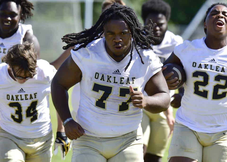 Offensive lineman Quory Ambrose (77) leads his teammates in drills at a practice session. The Oakleaf High School Knights football team practiced on the school’s practice field Tuesday, May 2, 2023 under new head coach Christopher Foy. [Bob Self/Florida Times-Union]