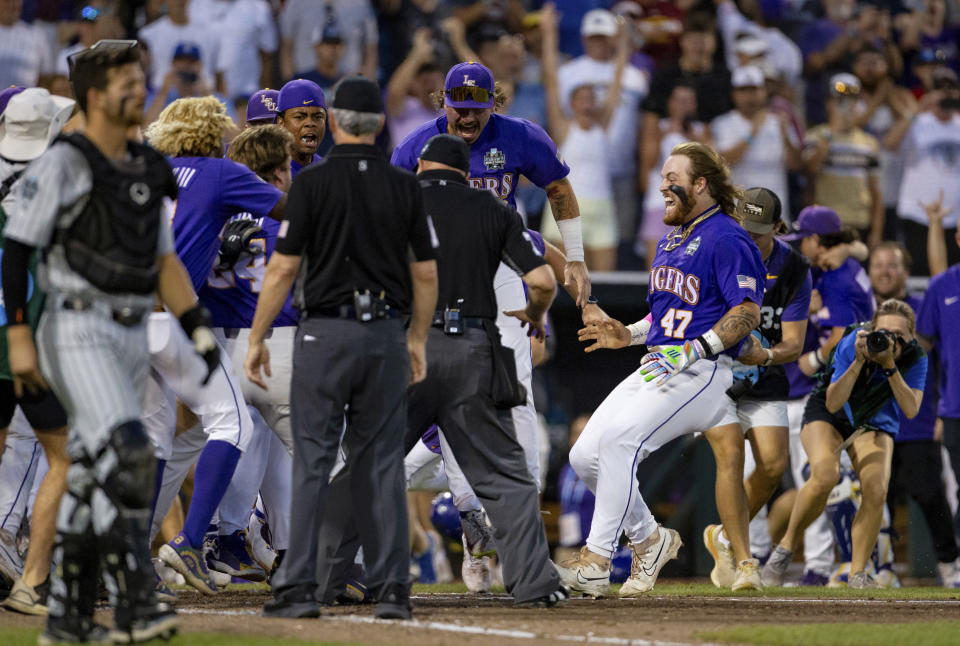 LSU's Tommy White (47) is greeted at the plate after his game-winning home run against Wake Forest during the 11th inning of a baseball game at the NCAA College World Series in Omaha, Neb., Thursday, June 22, 2023. (AP Photo/John Peterson)