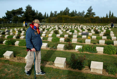 An Australian visitor walks between tombstones of Australian soldiers at the Ariburnu Memorial after attending a dawn ceremony marking the 104th anniversary of the World War One battle of Gallipoli, at Anzac Cove in the Gallipoli peninsula in Canakkale, Turkey, April 25, 2019. REUTERS/Kemal Aslan