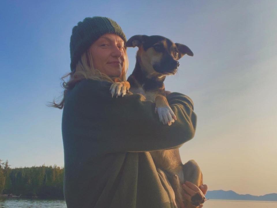 A woman holding a dog.