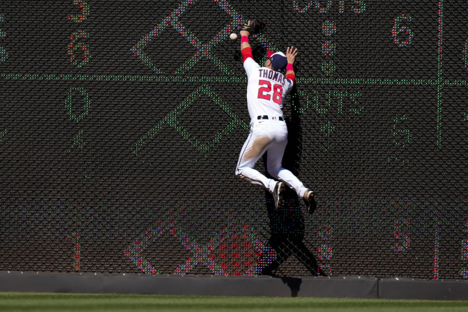Washington Nationals right fielder Lane Thomas can't catch a ball hit by Atlanta Braves' Michael Harris II for a double during the seventh inning of a baseball game at Nationals Park, Sunday, April 2, 2023, in Washington. The Nationals won 4-1. (AP Photo/Alex Brandon)