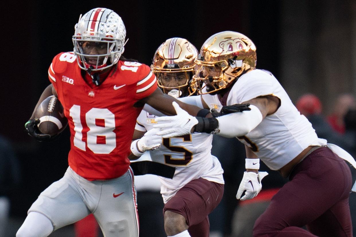 Nov 18, 2023; Columbus, Ohio, USA; 
Ohio State Buckeyes wide receiver Marvin Harrison Jr. (18) pushes off Minnesota Golden Gophers linebacker Devon Williams (9) as he runs down the field during the first half of their game on Saturday, Nov. 18, 2023 at Ohio Stadium.