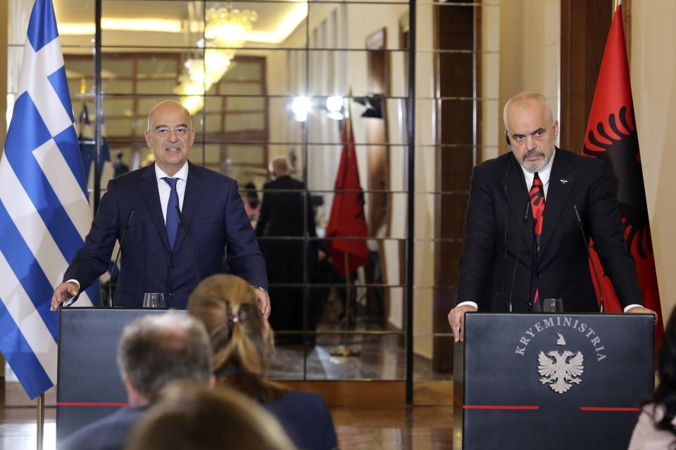 Greek Foreign Minister Nikos Dendias, left, makes a statement with the Albanian Prime Minister Edi Rama in Tirana, Tuesday, Oct. 20, 2020. Bilateral issues and maritime border delimitation in the Ionian Sea were the main topics of their discussion. (AP Photo/Hektor Pustina)