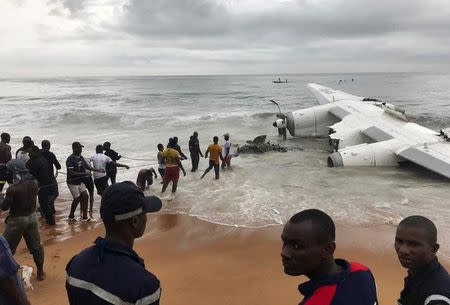People pull the wreckage of a propeller-engine cargo plane after it crashed in the sea near the international airport in Ivory Coast's main city, Abidjan, October 14, 2017. REUTERS/Ange Aboa