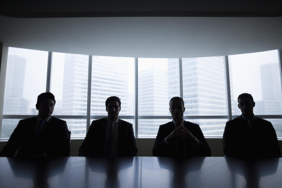 Silhouette row of businessmen sitting in meeting room