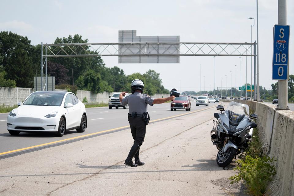 Jul 26, 2023; Columbus, OH, United States; State Highway Patrol Sgt. Cory Diehl, motions a car to pull over during their zero-tolerance speeding and reckless driving enforcement day.