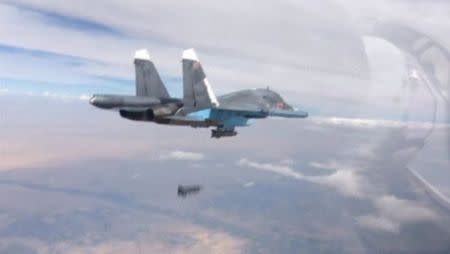 A frame grab taken from footage released by Russia's Defence Ministry October 9, 2015, shows a Russian Su-34 fighter-bomber dropping a bomb in the air over Syria. REUTERS/Ministry of Defence of the Russian Federation/Handout via Reuters