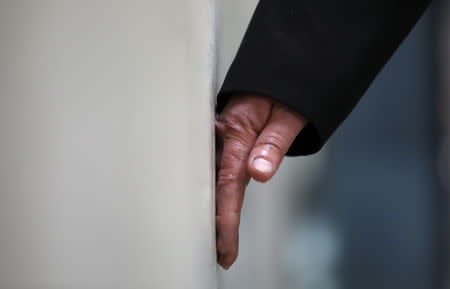 The hand of a demonstrator is seen glued to a wall of the London stock exchange during an Extinction Rebellion protest in London, Britain April 25, 2019. REUTERS/Simon Dawson