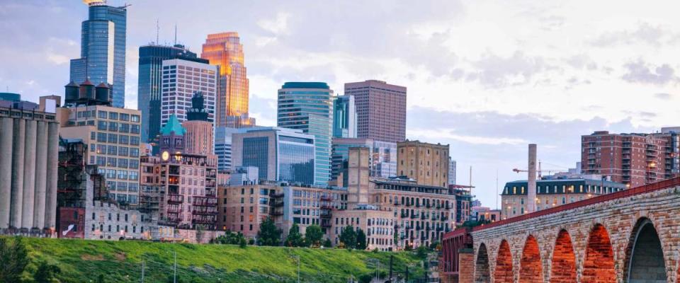 Downtown Minneapolis, Minnesota at night time as seen from the famous stone arch bridge