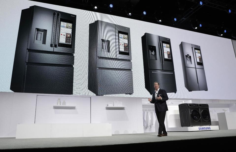 John Herrington, senior vice president of Samsung Electronics America, unveils new refrigerators with Family Hub 2.0 during a Samsung news conference before CES International, Wednesday, Jan. 4, 2017, in Las Vegas. Family Hub 2.0 features an interface on the refrigerator with apps that can be controlled by voice recognition. (AP Photo/John Locher)