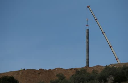 A crane removes steel tubes after failing to place them into the drilled well at the area where Julen, a Spanish two-year-old boy, fell into a deep well nine days ago when the family was taking a stroll through a private estate, in Totalan, southern Spain January 22, 2019. REUTERS/Jon Nazca