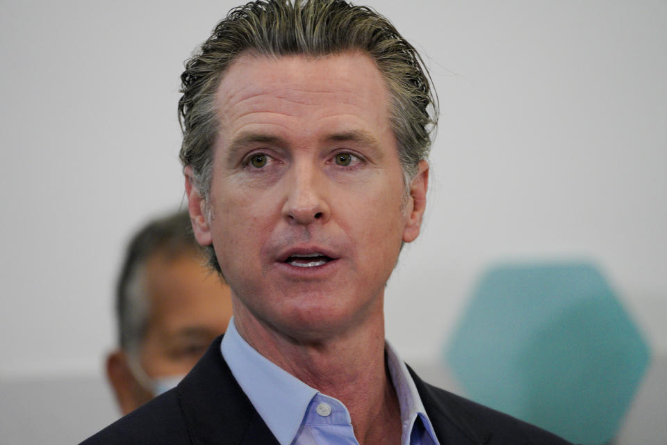 Governor Gavin Newsom speaks with news reporters at Park de la Cruz Recreation Center on Friday, April 2, 2021 in San Diego about the San Diego's newest pop-up vaccination site in the City Heights neighborhood. (Nelvin C. Cepeda/The San Diego Union-Tribune via AP)