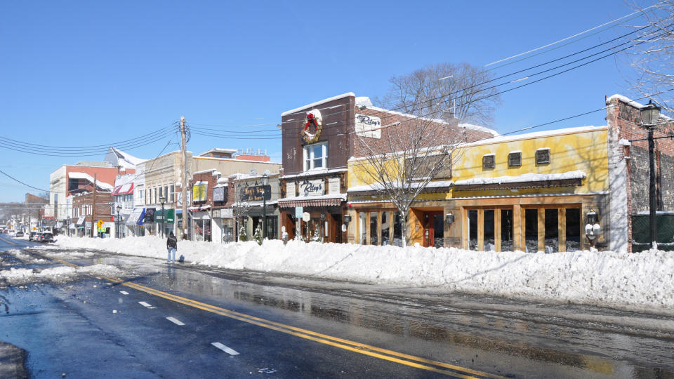 HUNTINGTON, NEW YORK - FEB 9: Huntington Village shopping district main streets cleared less than 24 hours after the Feb 8 blizzard that dumped 1-2 ft of snow on Huntington, New York.