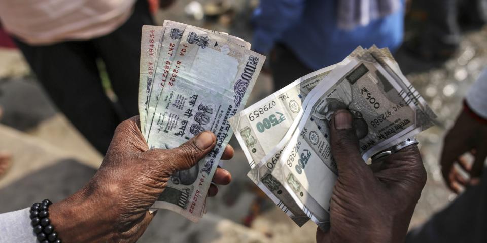 A man counts Indian rupee banknotes in Varanasi, Uttar Pradesh, India.