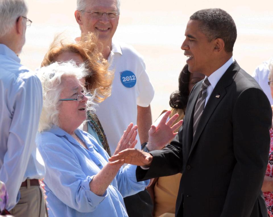 President Barack Obama is greeted after arriving on Air Force One at the Eastern Iowa Airport in Cedar Rapids, Iowa, Tuesday July 10, 2012. (AP Photo/Conrad Schmidt)