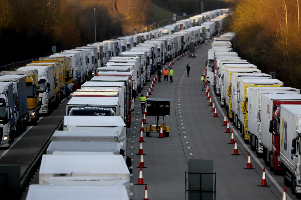 Trucks are parked up on the M20, part of Operation Stack in Ashford, Kent, England, Friday, Dec. 25, 2020. Thousands wait to resume their journey across The Channel after the borders with France reopened. Trucks inched slowly past checkpoints in Dover and headed across the Channel to Calais on Thursday after France partially reopened its borders following a scare over a rapidly spreading new virus variant. (AP Photo/Kirsty Wigglesworth)