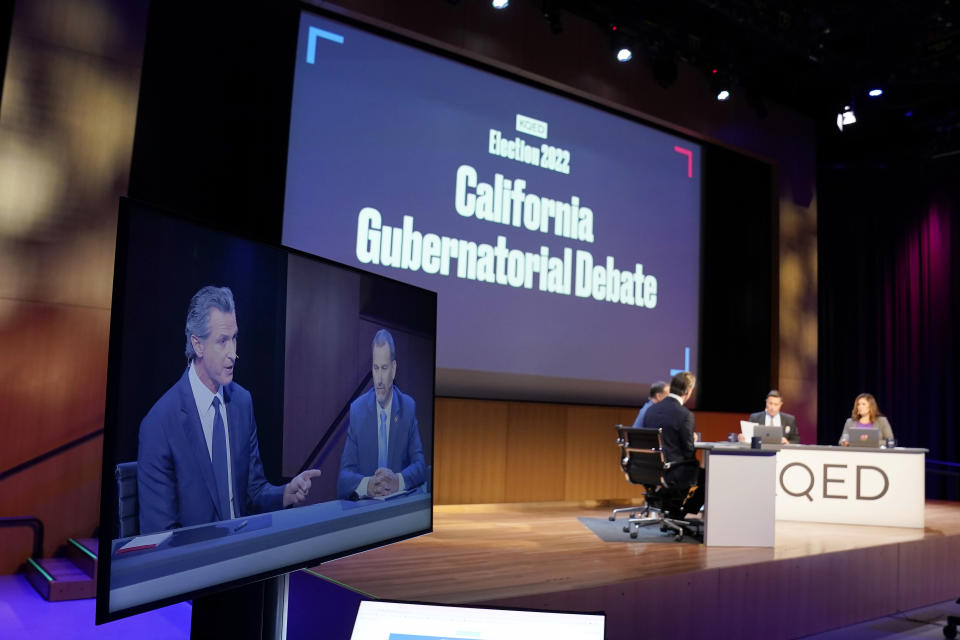 Gubernatorial candidates, Democratic Gov. Gavin Newsom, left, and Republican challenger state Sen. Brian Dahle are seen on a display during their debate held by KQED Public Television in San Francisco, on Sunday, Oct. 23, 2022. (AP Photo/Rich Pedroncelli, Pool)