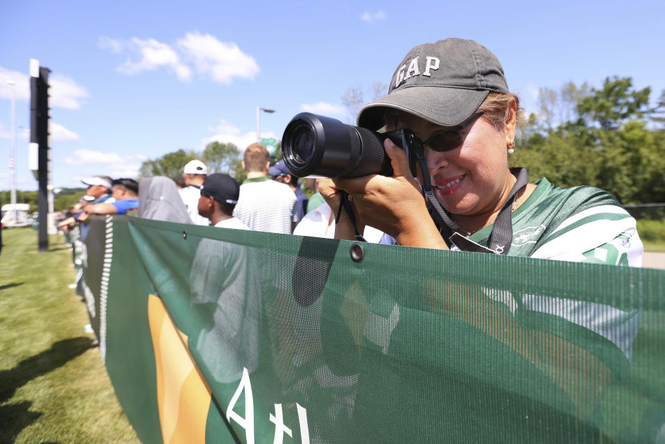 A fan takes a photo during New York Jets practice at the team's NFL football training facility, Saturday, July. 31, 2021, in Florham Park, N.J. (AP Photo/Rich Schultz)