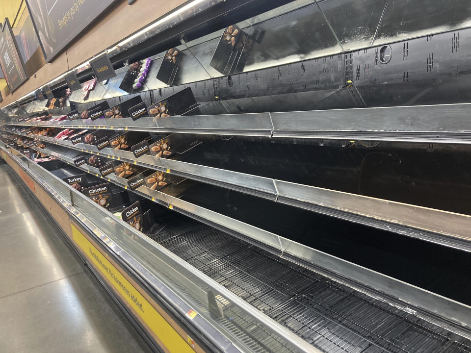 Shelves sit empty at a Walmart in Anchorage, Alaska, on Jan. 8, 2022. Shortages at U.S. grocery stores have grown in recent weeks as new problems — like the fast-spreading omicron variant and severe weather — have piled on to the supply chain struggles and labor shortages that have plagued retailers since the coronavirus pandemic began. (AP Photo/Mark Thiessen)