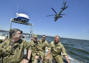 Ukraine's President Petro Poroshenko (L) inspects a military drill with the Secretary of the National Security and Defense Council of Ukraine Oleksandr Turchynov (2nd L), in the waters of the Black Sea in Mykolaiv region, Ukraine, in this July 21, 2015 file photo. REUTERS/Mykola Lazarenko/Ukrainian Presidential Press Service/Handout via Reuters/Files