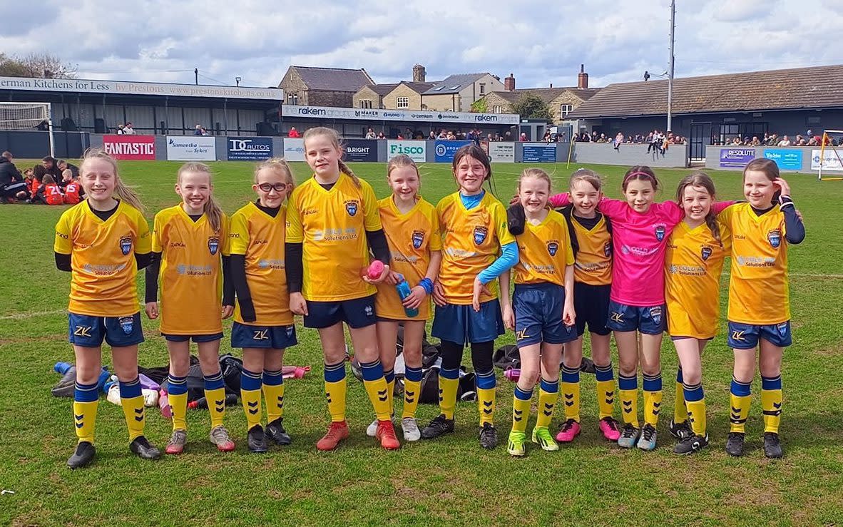 An under-10s team has made history in a famous football town as the first all-girl team to win the Vase trophy