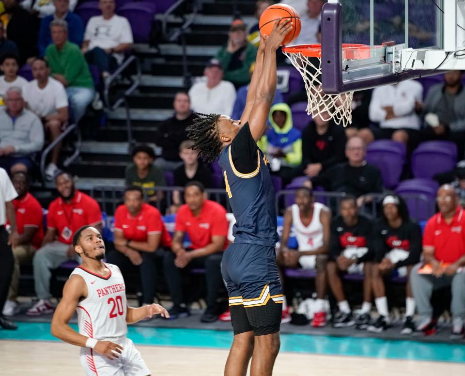 Wheeler Wildcats guard Isaiah Collier (4) dunks during the first half of the City of Palms Classic semifinal game against the Imhotep Charter Panthers at Suncoast Arena in Ft. Myers on Tuesday, Dec. 20, 2022.