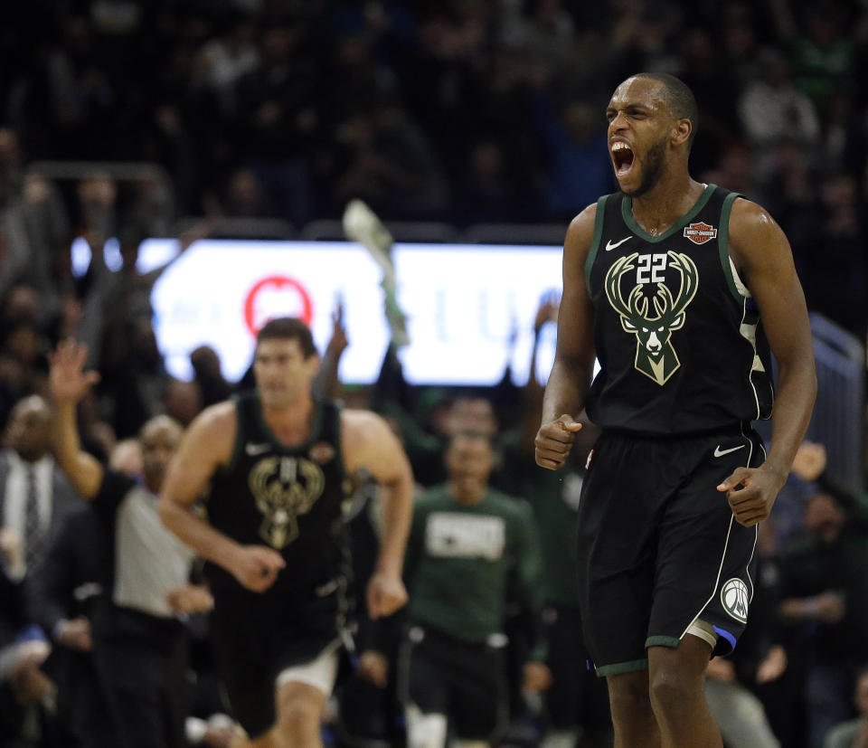 Milwaukee Bucks’ Khris Middleton, right, reacts after making a three-point basket during the second half of an NBA basketball game against the Boston Celtics, Thursday, Feb. 21, 2019, in Milwaukee. (AP Photo/Aaron Gash)