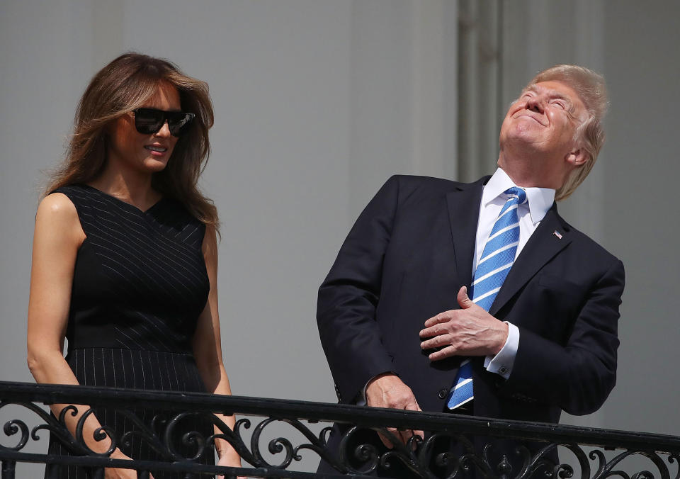 <p>AUG. 21, 2017 – President Donald Trump looks up toward the Solar Eclipse while joined by his wife first lady Melania Trump on the Truman Balcony at the White House on in Washington, DC. Millions of people have flocked to areas of the U.S. that are in the “path of totality” in order to experience a total solar eclipse. (Photo: Mark Wilson/Getty Images) </p>