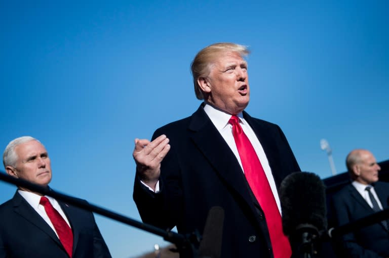 US Vice President Mike Pence (L) and White House Chief of Staff John Kelly (R) listen as US President Donald Trump speaks to the press on January 18, 2018 in Washington, DC