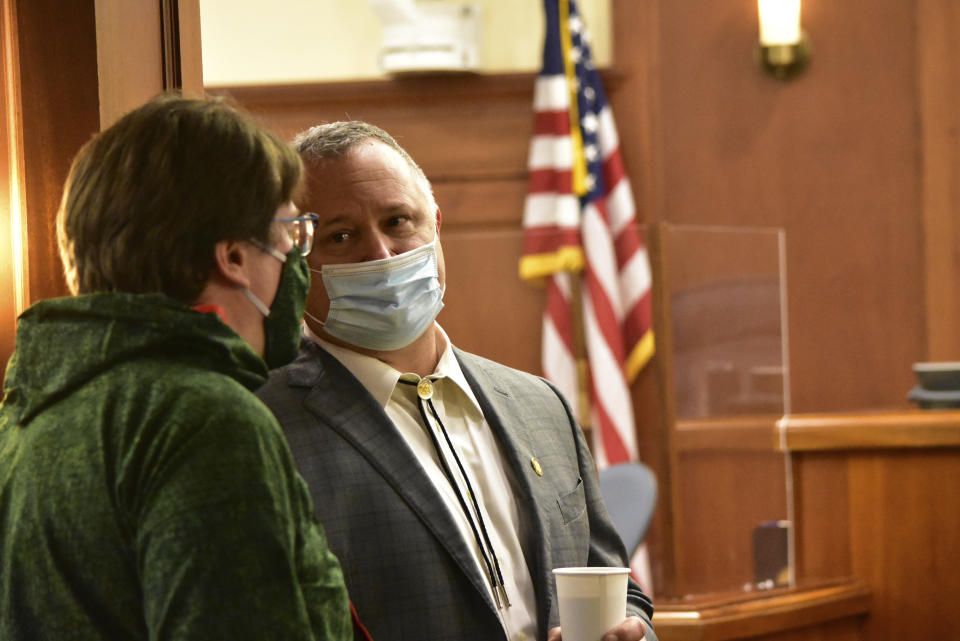 State Sens. Mike Shower, R-Wasilla, right, and Robert Myers, R-North Pole, wait for their colleagues to arrive for the of the Alaska state Senate on Friday, Jan. 22, 2021, in Juneau, Alaska. (Peter Segall/The Juneau Empire via AP, Pool)