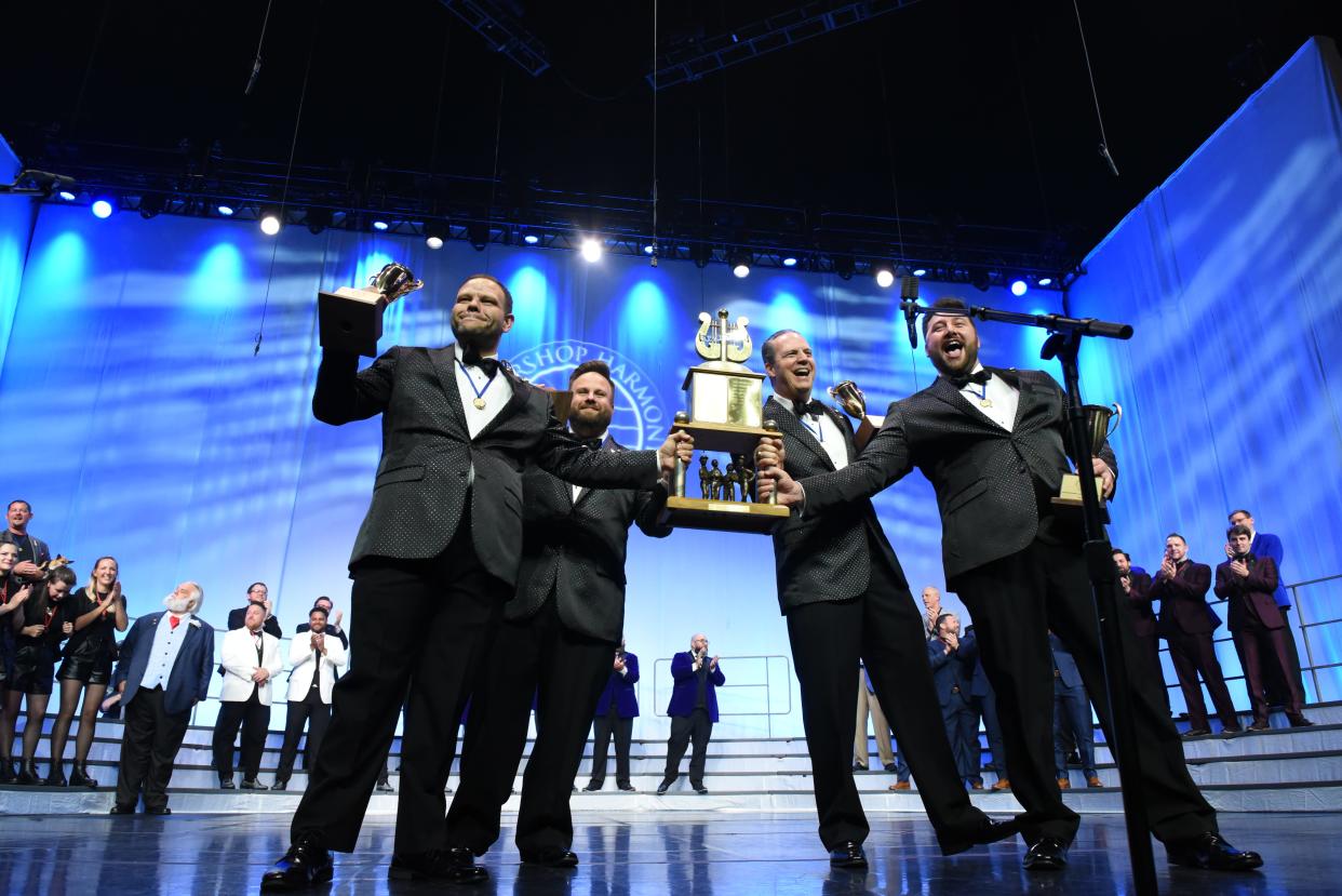 The barbershop quartet Quorum shows off its first-place trophy and other awards July 9 at the  2022 International Quartet Contest in Charlotte, North Carolina. The group includes baritone Nathan Johnston of Fort Myers (far right).