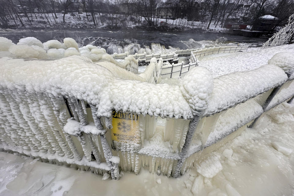 Mist from the Great Falls has created a frozen wonderland around the waterfalls in Paterson, N.J., on Thursday, Jan. 18, 2024. People are braving the subfreezing cold temps and slippery walkways to visit the ice-covered trees, benches and lamposts. (AP Photo/Ted Shaffrey)