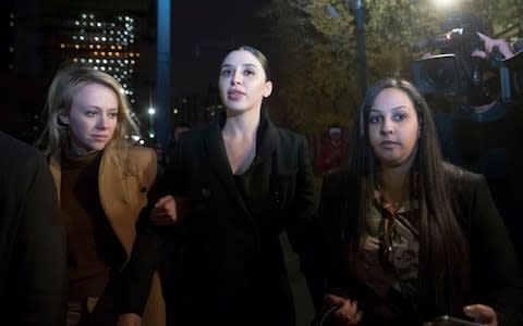 Emma Coronel, center, the wife of Joaquin "El Chapo" Guzman leaves Brooklyn Federal court after opening arguments  - Credit: AP