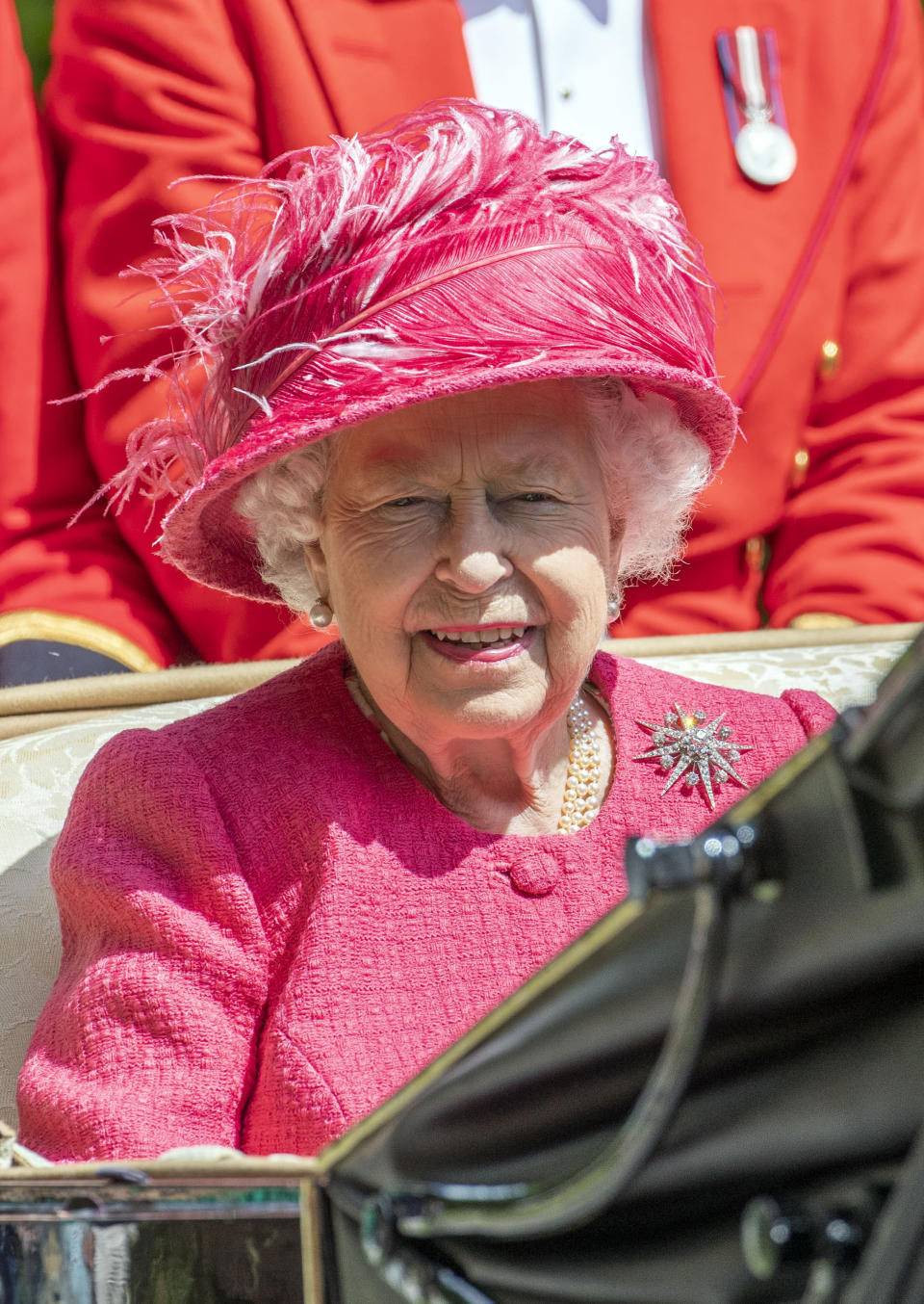 The Queen looks perfect in raspberry pink for day four of the races.<em> [Photo: PA]</em>