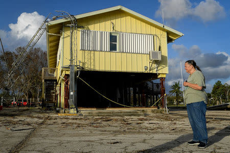 Brenda Hamilton, 62, surveys the damage from Hurricane Irma at her business in Everglades City, Florida, U.S., September 11, 2017. REUTERS/Bryan Woolston